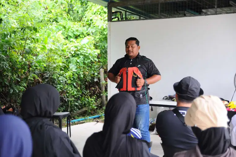Safety briefing and life jacket fitting before kayaking